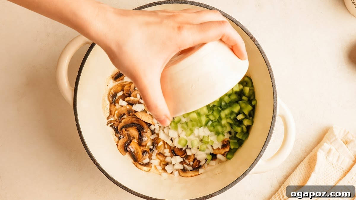 Loaded Cheesy Pizza Bowl Recipe for Weeknight Dinner 5 Step 2: mushrooms, onion, and green pepper cooking together in a pot.
