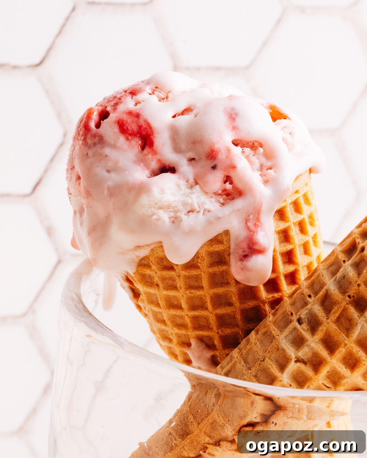 Creamy Homemade Strawberry Ice Cream Recipe 2 Scoop of homemade strawberry ice cream in a cone.