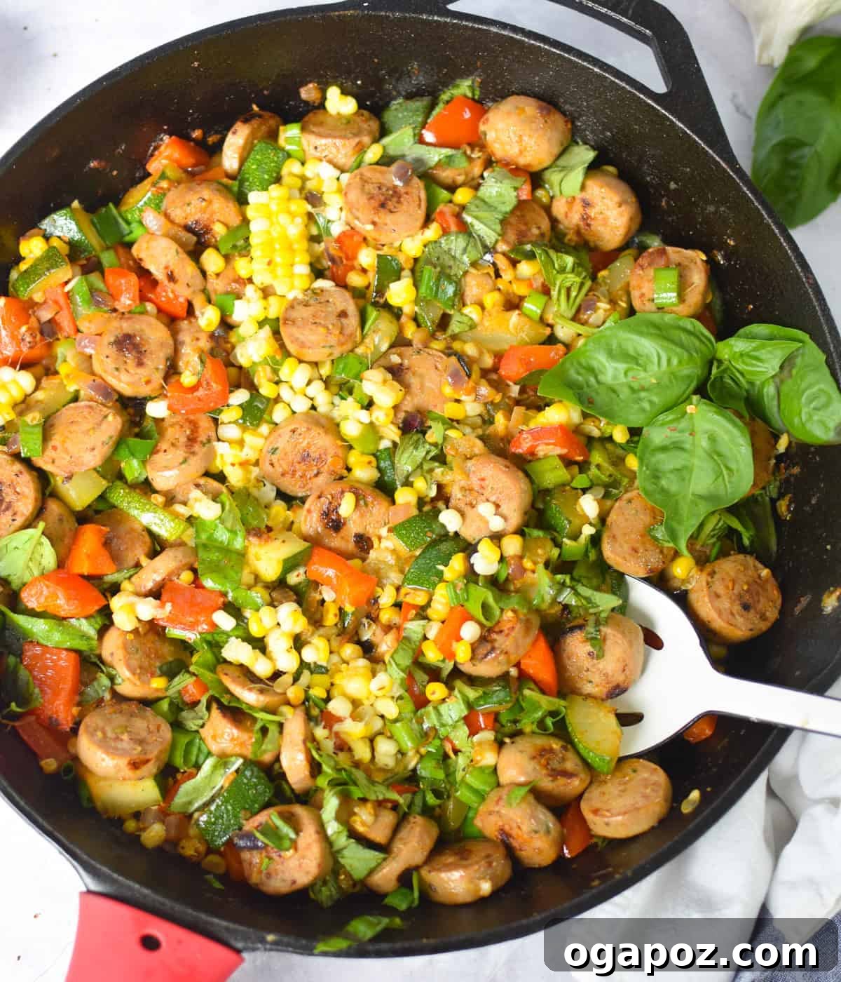 One-Pan Sausage and Vegetable Skillet 2 Overhead shot of one-pan sausage and veggie skillet with fresh basil on top