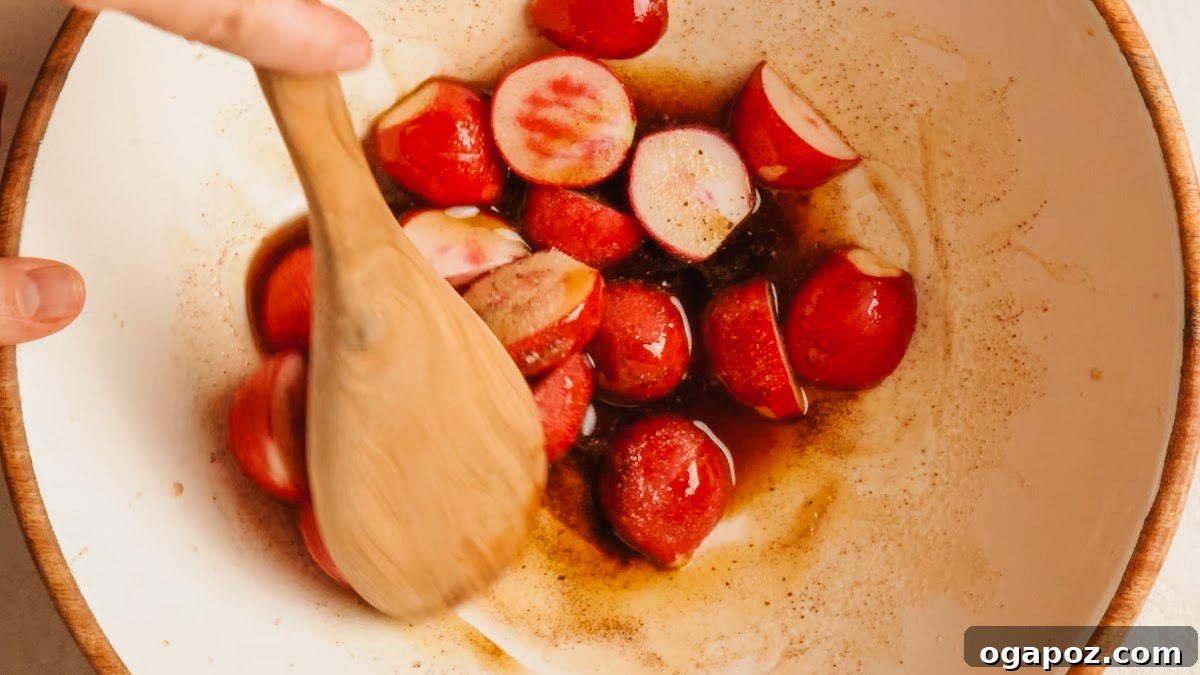 Crispy Oven-Roasted Radishes with Garlic and Herbs 8 Halved radishes tossed in brown butter in a large bowl.