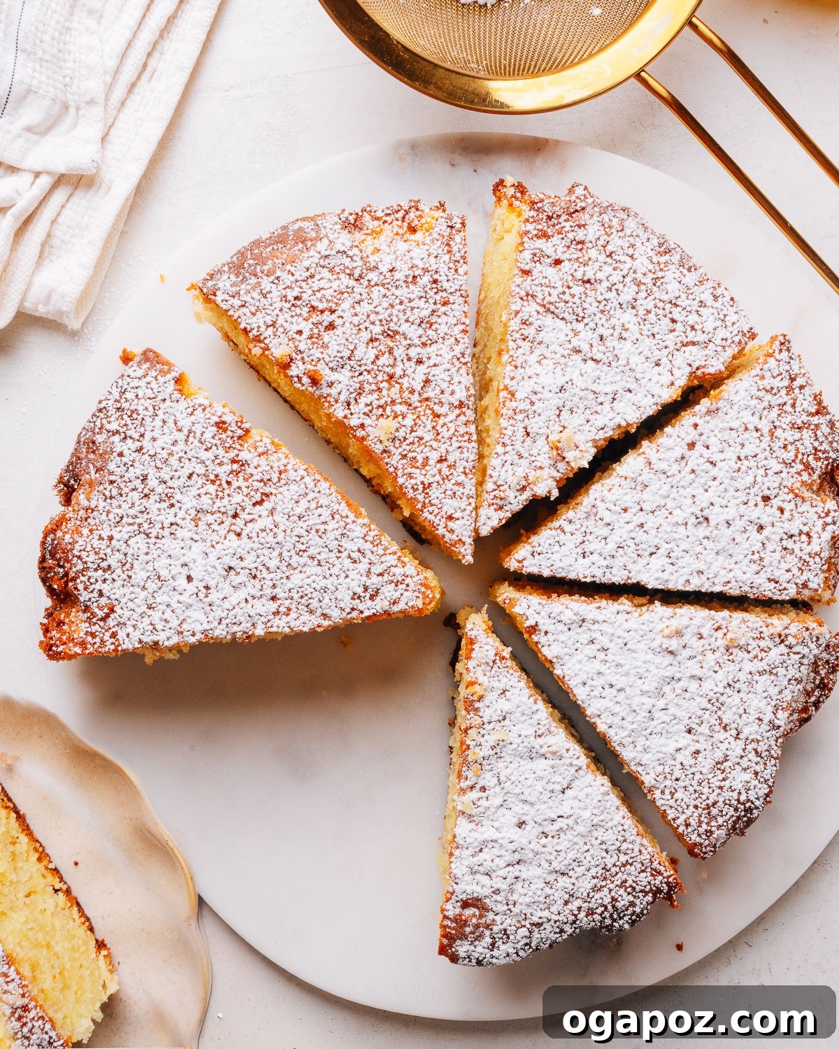 Moist Lemon Olive Oil Cake Recipe with Citrus Glaze 11 Olive oil cake sliced on a plate.