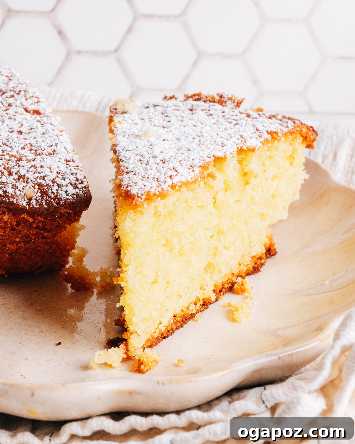 Moist Lemon Olive Oil Cake Recipe with Citrus Glaze 12 A slice of olive oil cake on a plate showing the soft, tender crumb.