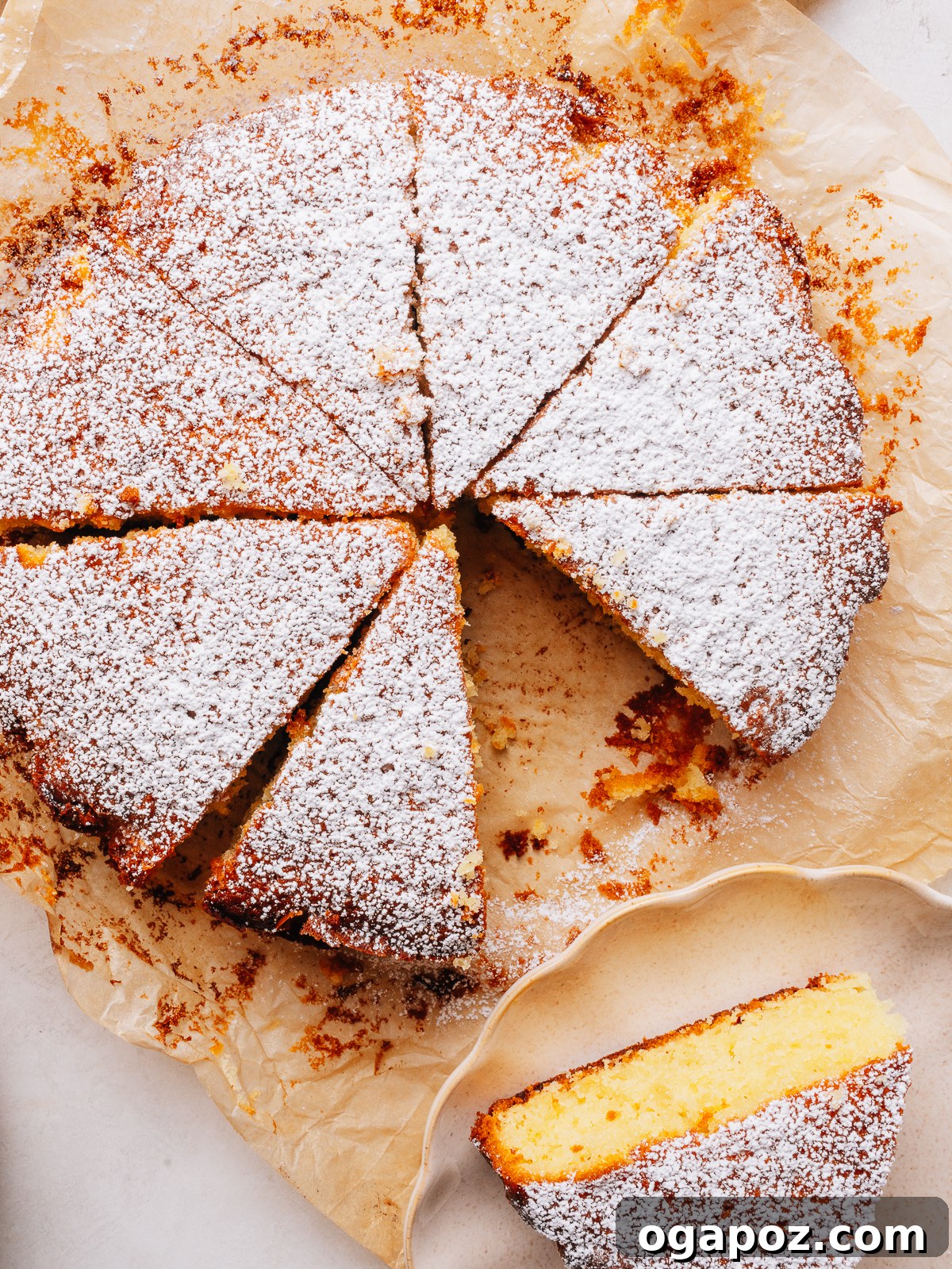 Moist Lemon Olive Oil Cake Recipe with Citrus Glaze 13 Slicing into the finished olive oil cake recipe and lifting a slice from the cake.