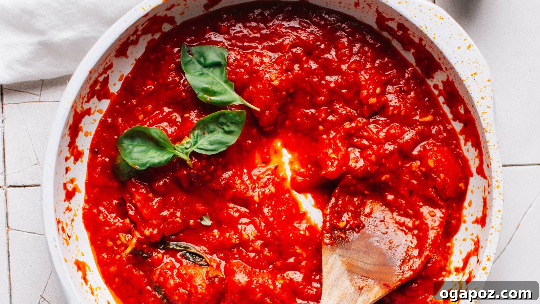 20 Fresh Tomato Recipes to Use Up Ripe Tomatoes 20 Thick homemade red pizza sauce in a bowl with a spoon.