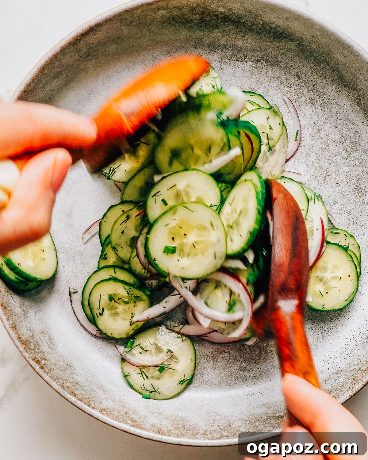 Cucumber Dill Salad with Vinegar Dressing 8 Dill and vinegar cucumber salad recipe being spooned onto a plate.