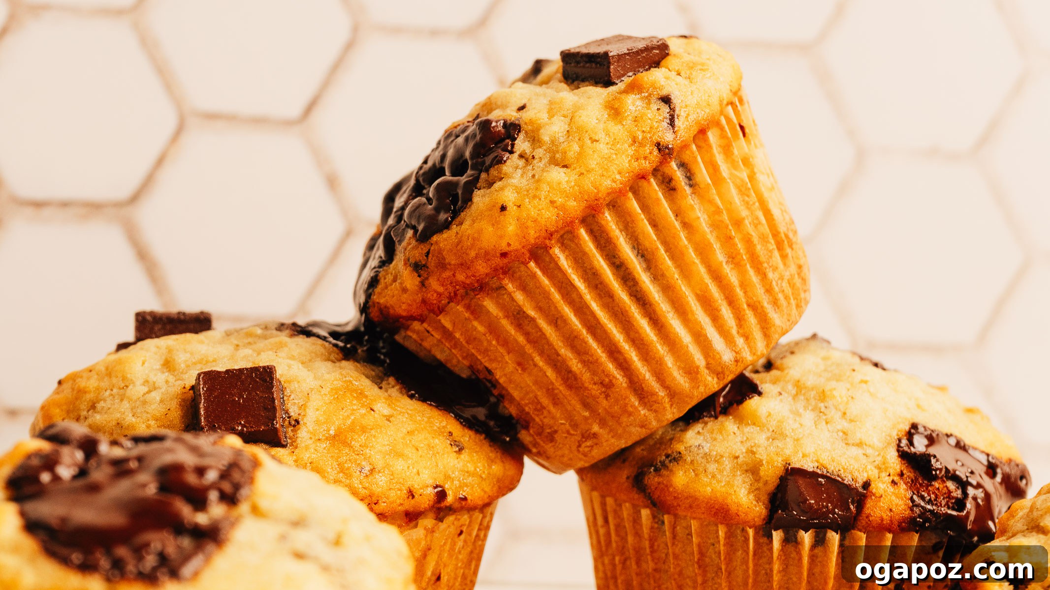 One-Bowl Banana Chocolate Chunk Muffins Soft and Moist 4 Close-up of a banana chocolate chip muffin with gooey chocolate chunks.