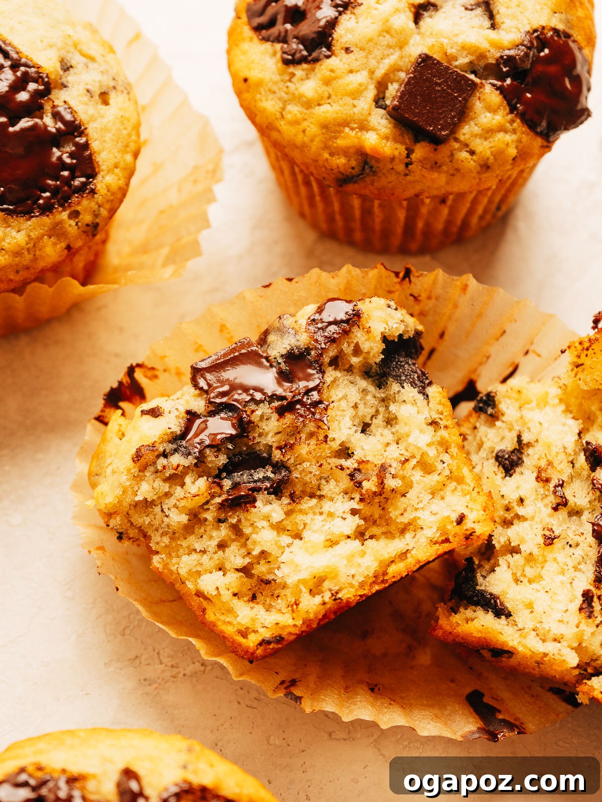 One-Bowl Banana Chocolate Chunk Muffins Soft and Moist 5 A batch of moist banana chocolate chip muffins ready to eat.