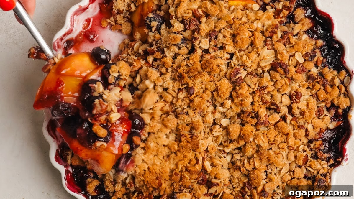 Peach Blueberry Crisp with Brown Sugar Oat Topping 9 Baked crisp with a golden topping and fruit bubbling at the edges.