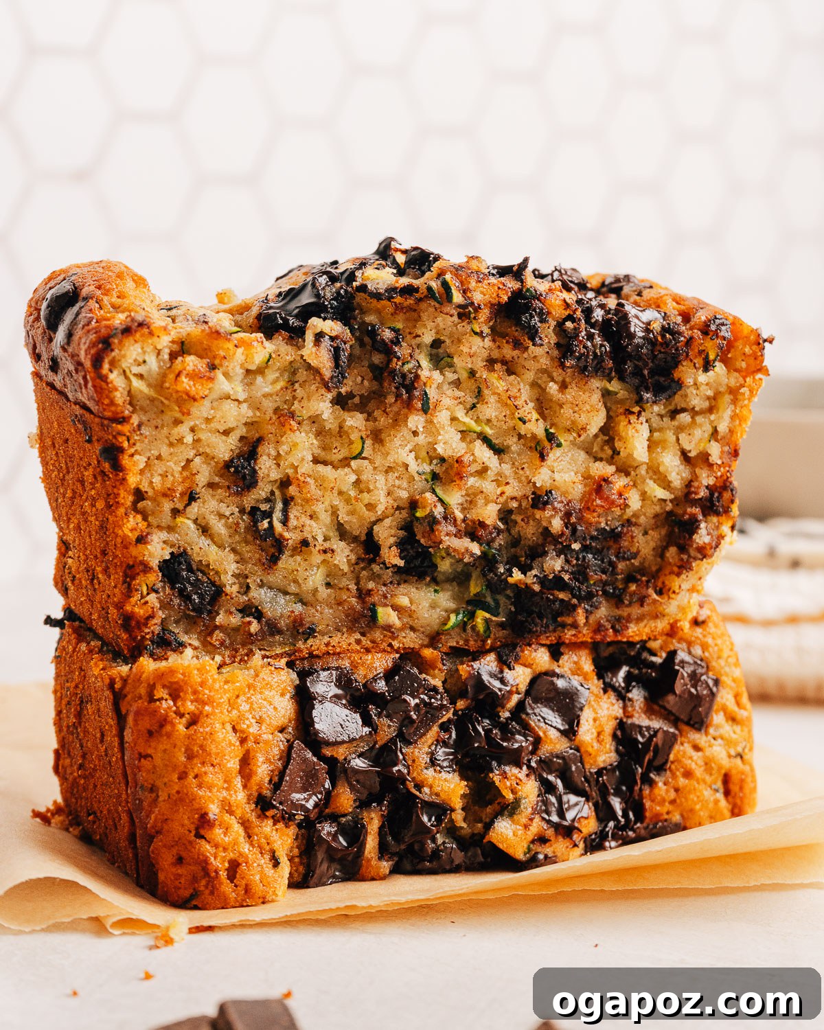 18 Zucchini Recipes to Use Up Every Last One 3 A sliced loaf of chocolate chip zucchini bread on a wooden board.