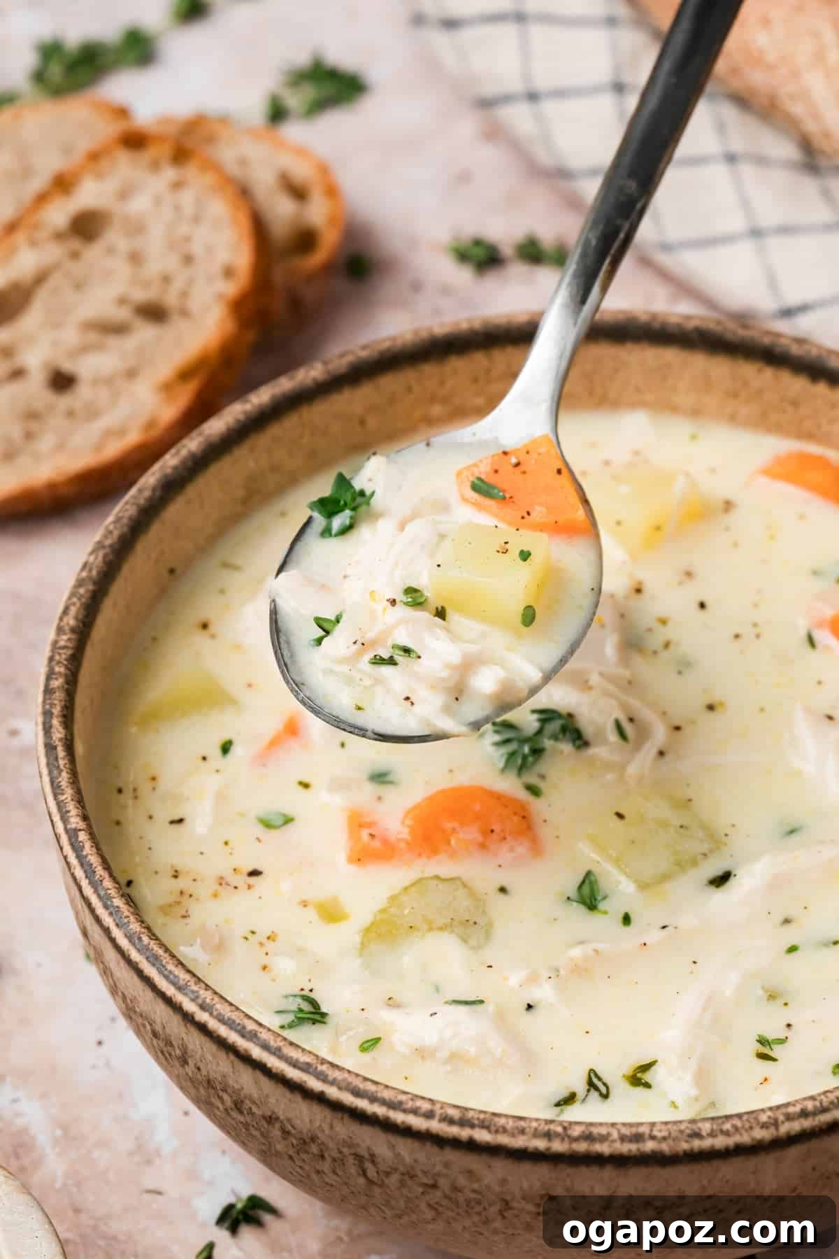 Creamy Chicken and Potato Soup Without Heavy Cream 2 Creamy chicken and potato soup in a bowl with a spoon lifting a bite showing shredded chicken and potatoes