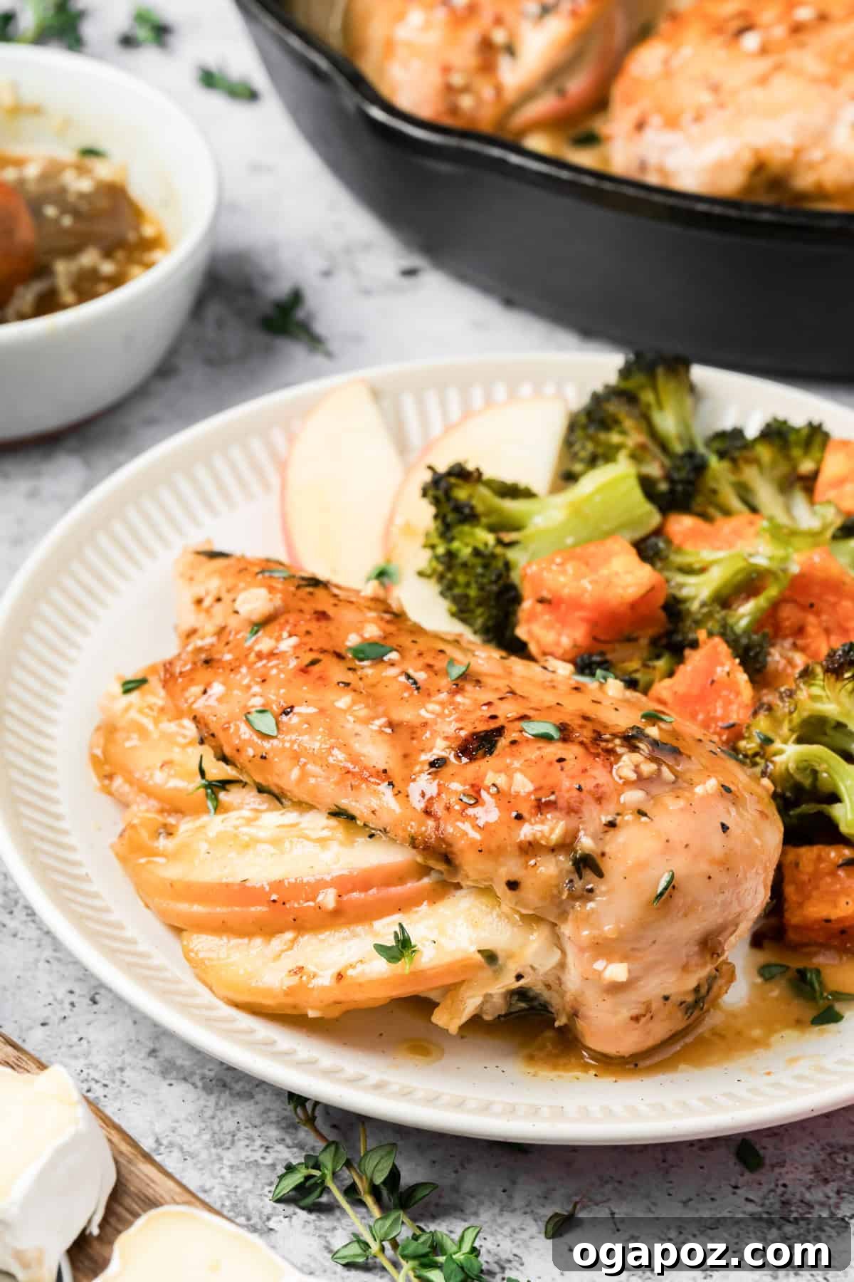 Apple and Brie Stuffed Chicken Breast Recipe 6 Sliced apple and brie stuffed chicken breast with melty cheese filling on a plate