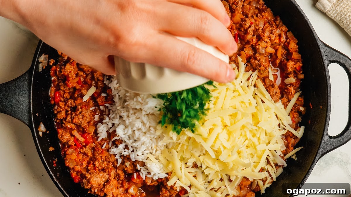 Classic Stuffed Green Peppers with Rice and Ground Beef 8 Adding rice, parsley and parmesan to the beef filling.