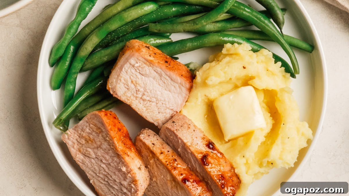 Oven-Baked Brown Sugar Boneless Pork Chops 9 Juicy baked boneless pork chops sliced and served.