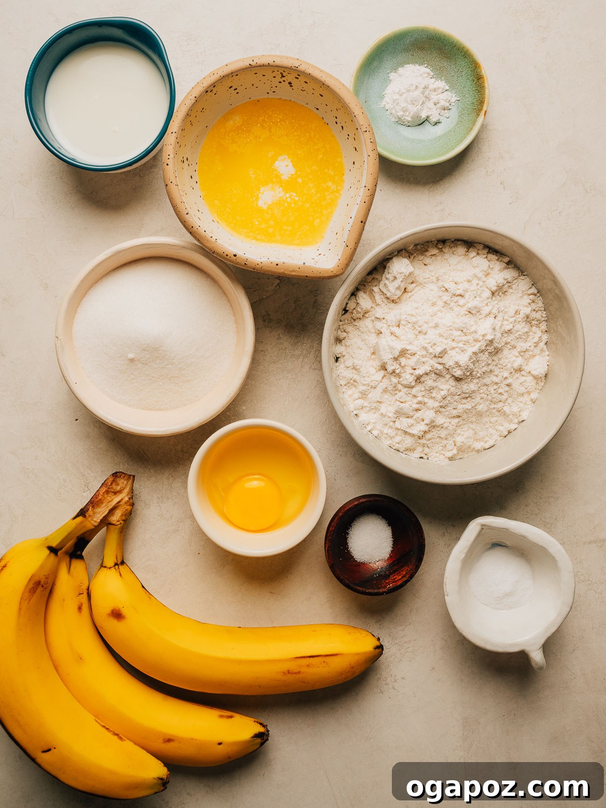 Moist Banana Bread Muffins That Stay Fresh for Days 3 Banana bread muffin ingredients in bowls with melted butter, an egg, flour, sugar, milk and ripe bananas.