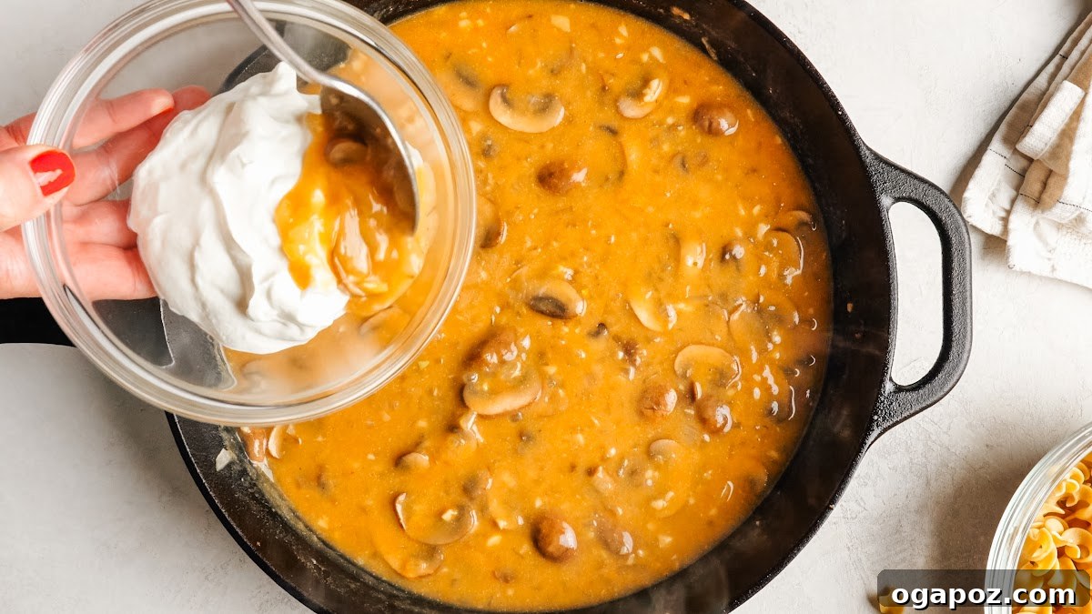 Creamy One-Pan Chicken Stroganoff 9 Tempering sour cream with a spoonful of the hot sauce.