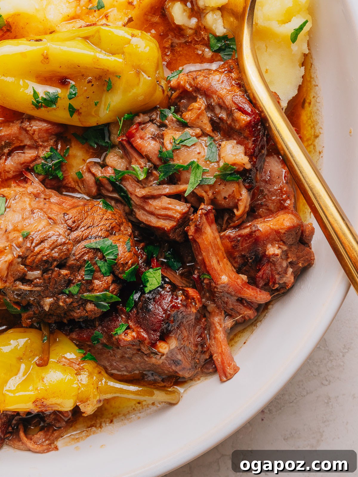 Slow-Cooker Mississippi Pot Roast Recipe for Tender, Flavorful Meat 10 Close-up of fork-tender Mississippi pot roast beef with pepperoncini and parsley.