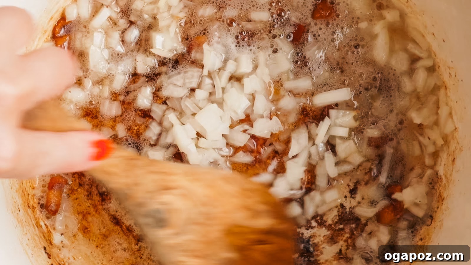 Chopped onion softening in the rendered bacon fat.
