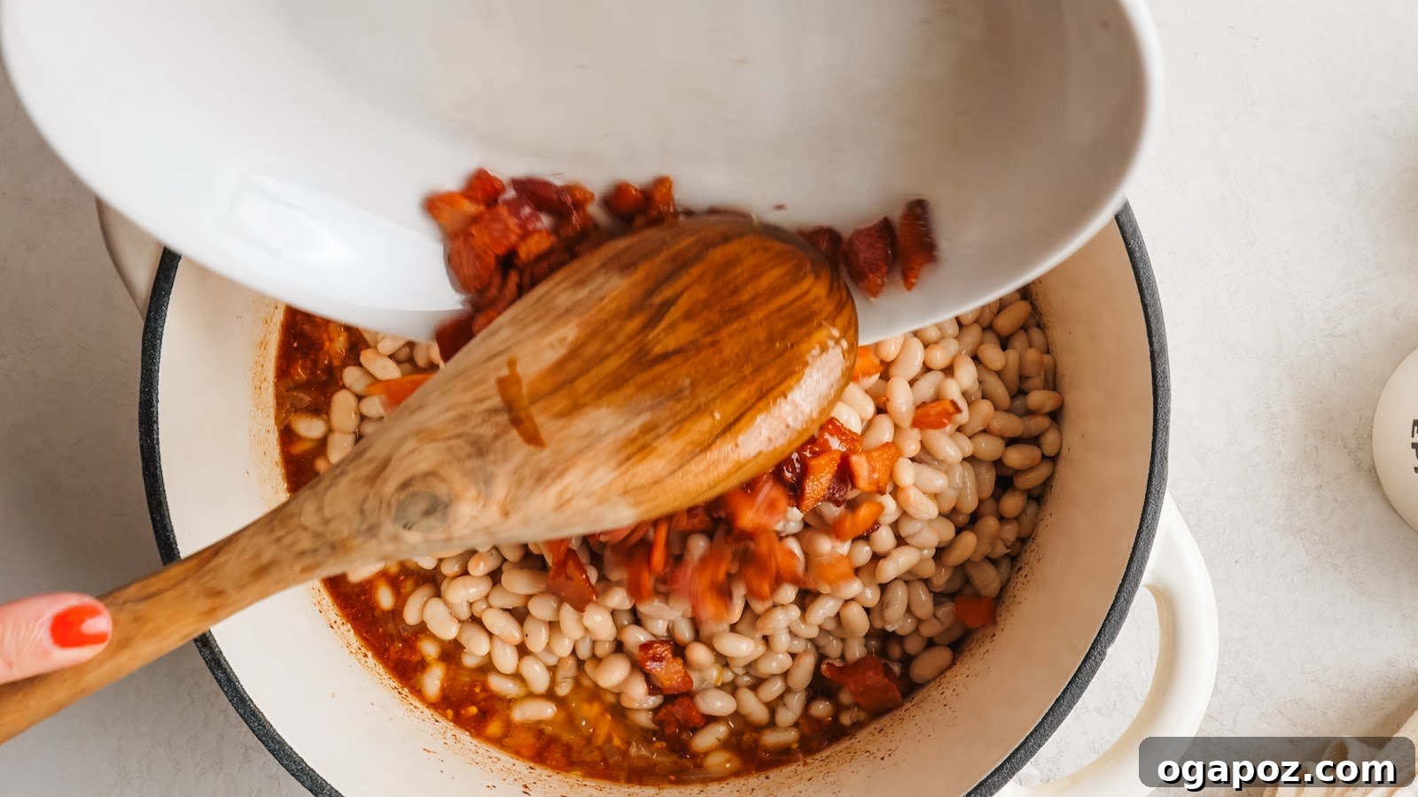 Canned cannellini beans and bacon stirred into the sauce.