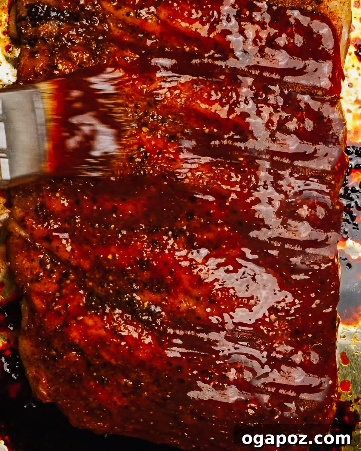 Homemade Award-Winning Brown Sugar BBQ Sauce 9 Brushing brown sugar bbq sauce on ribs.