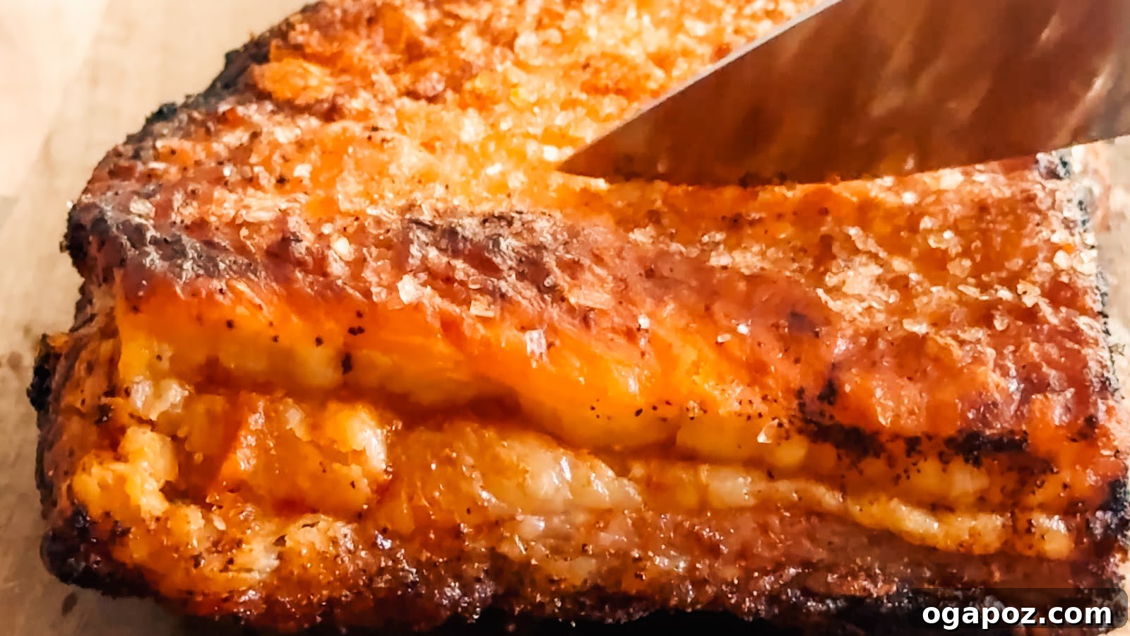 Sliced crispy pork belly showing layers of tender meat and blistered crackling.