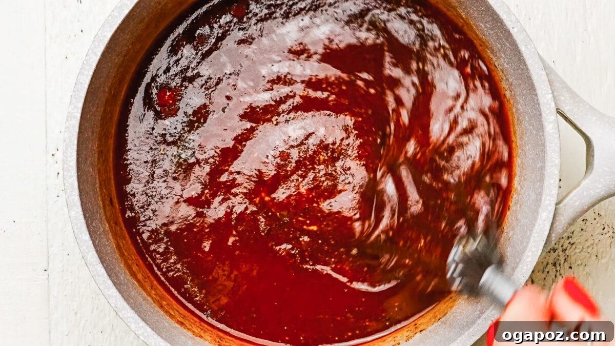 Finished honey BBQ sauce in a saucepan.