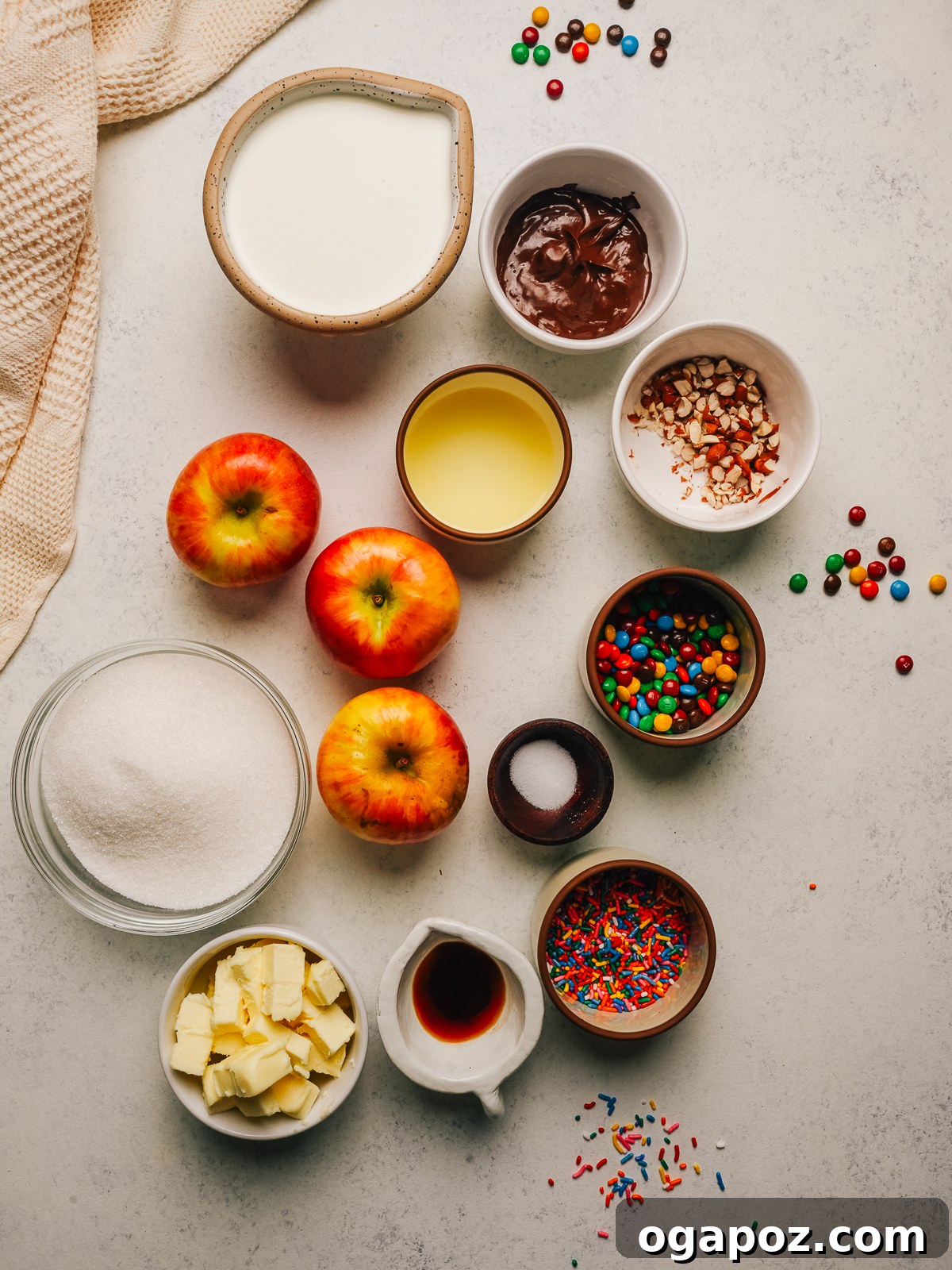 Ingredients for caramel apple slices, including apples, sugar, heavy cream, butter, vanilla and toppings.