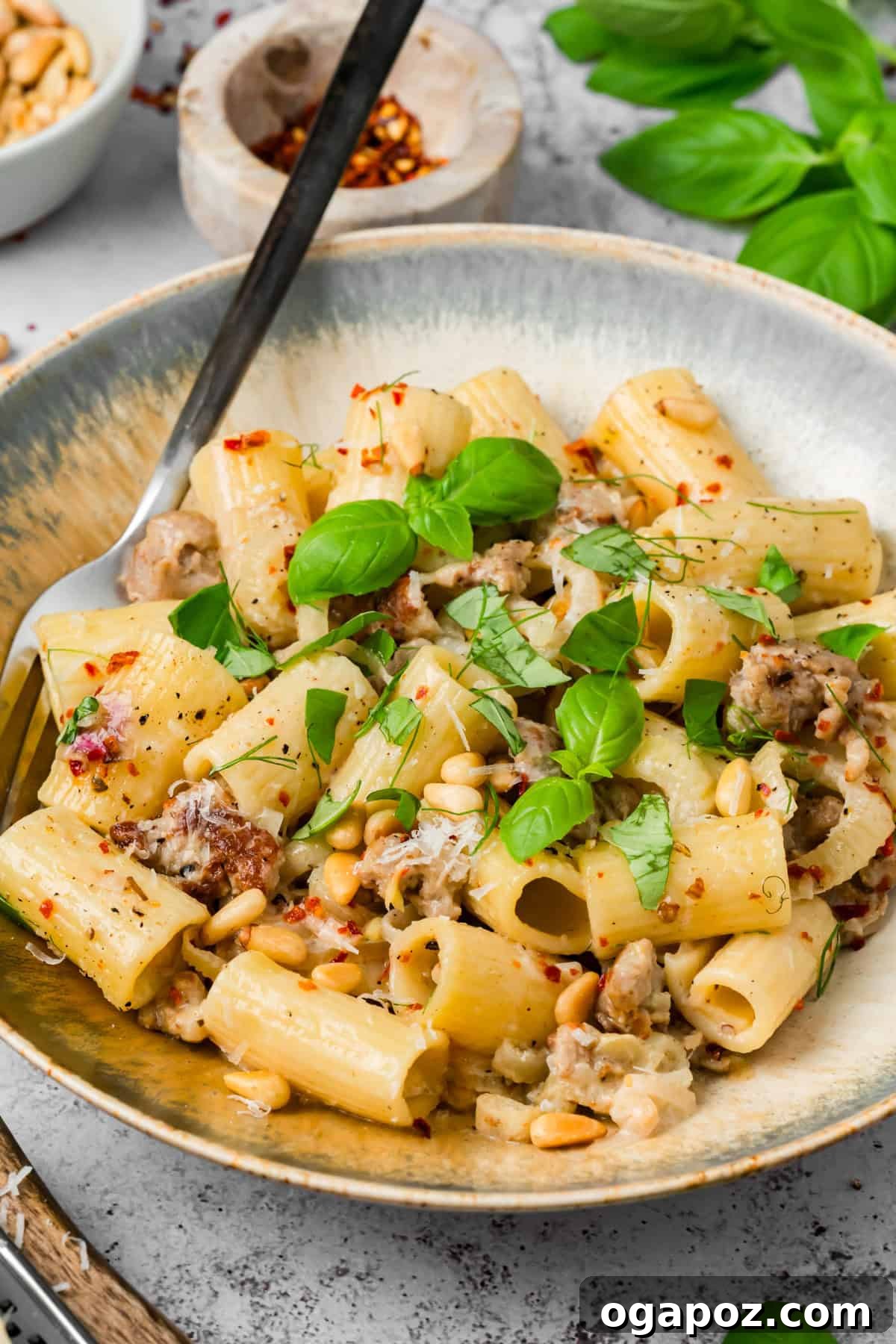 Creamy Italian Sausage and Fennel Pasta with Parmesan 2 Creamy sausage and fennel pasta on a plate with a fork twirling rigatoni coated in white wine cream sauce