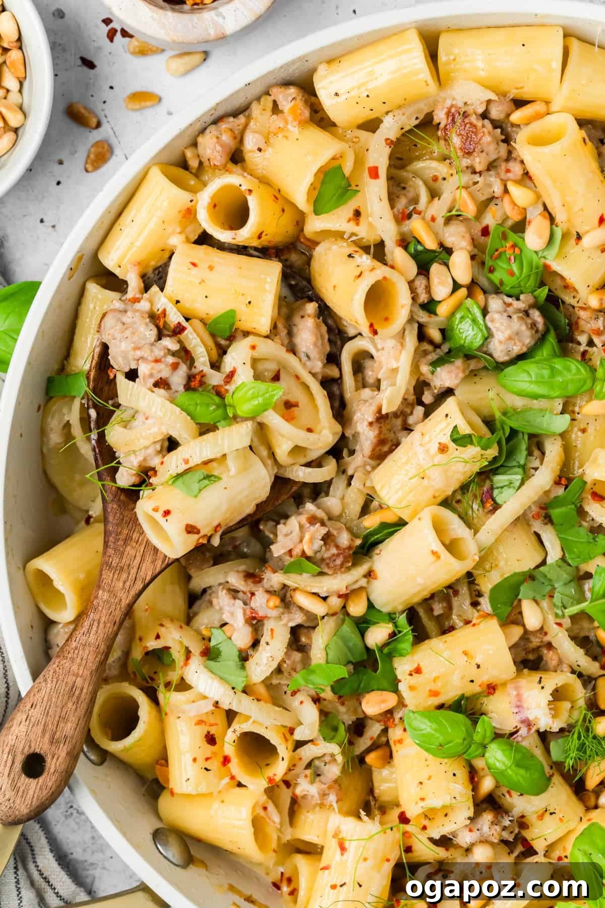 Creamy Italian Sausage and Fennel Pasta with Parmesan 6 Close-up of creamy sausage and fennel pasta topped with toasted pine nuts and Parmesan